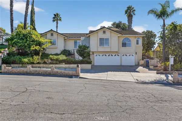 a front view of a house with a yard and a garage