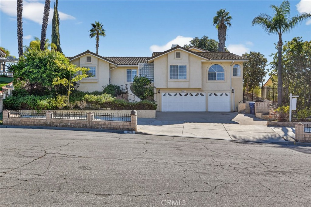 a front view of a house with a yard and a garage