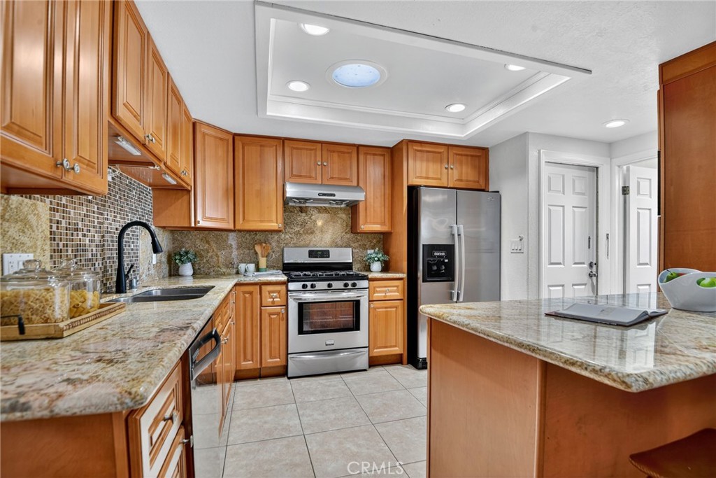 20122 Candleflame Court Walnut, CA 91789 - Photo 12 of 61 a kitchen with stainless steel appliances granite countertop a sink stove and refrigerator