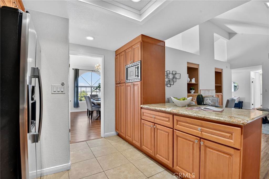 20122 Candleflame Court Walnut, CA 91789 - Photo 13 of 61 a bathroom with a granite countertop sink a mirror and a refrigerator