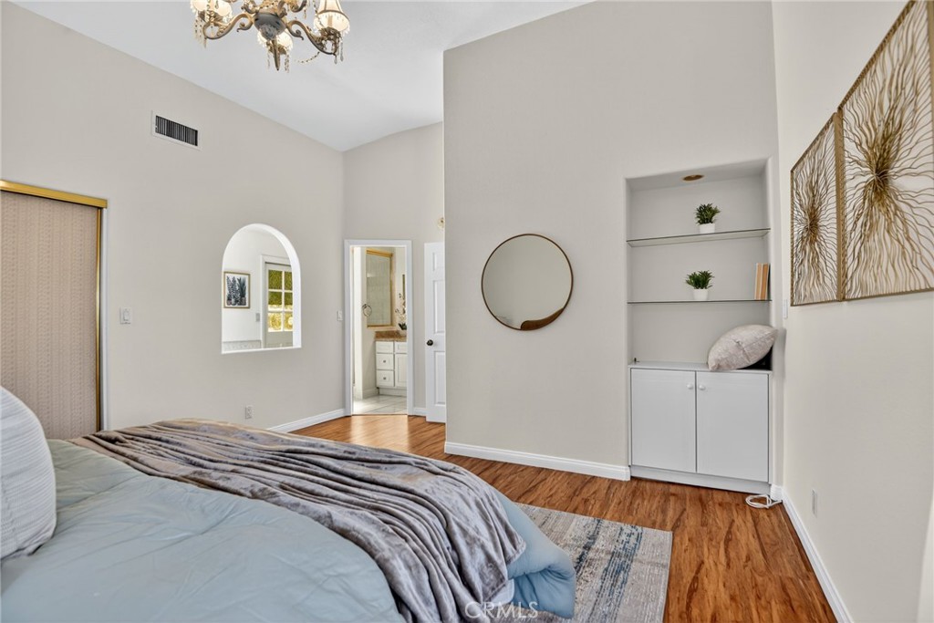 20122 Candleflame Court Walnut, CA 91789 - Photo 18 of 61 a bedroom with a bed and a chandelier