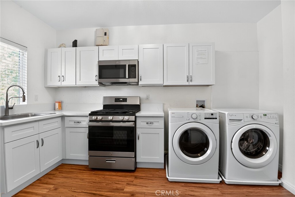 20122 Candleflame Court Walnut, CA 91789 - Photo 35 of 61 a kitchen with white cabinets and stainless steel appliances