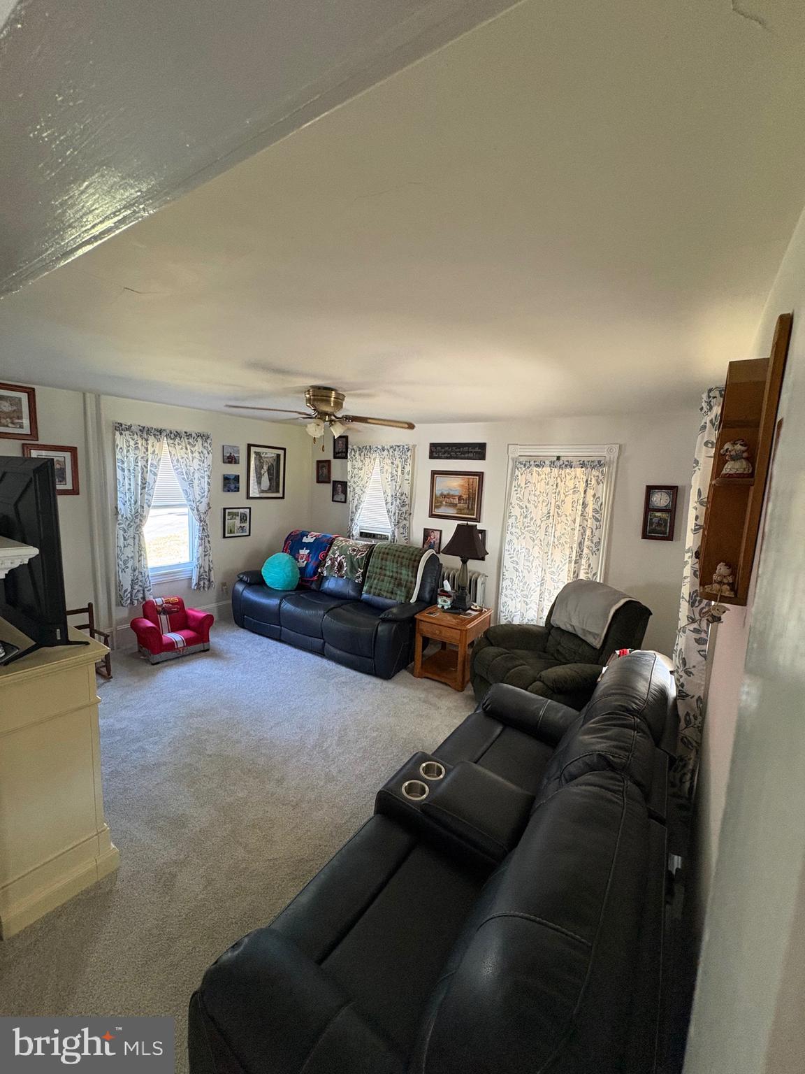 909 Main Street Salem, NJ 08079 - Photo 16 of 35 a living room with furniture a window and a flat screen tv