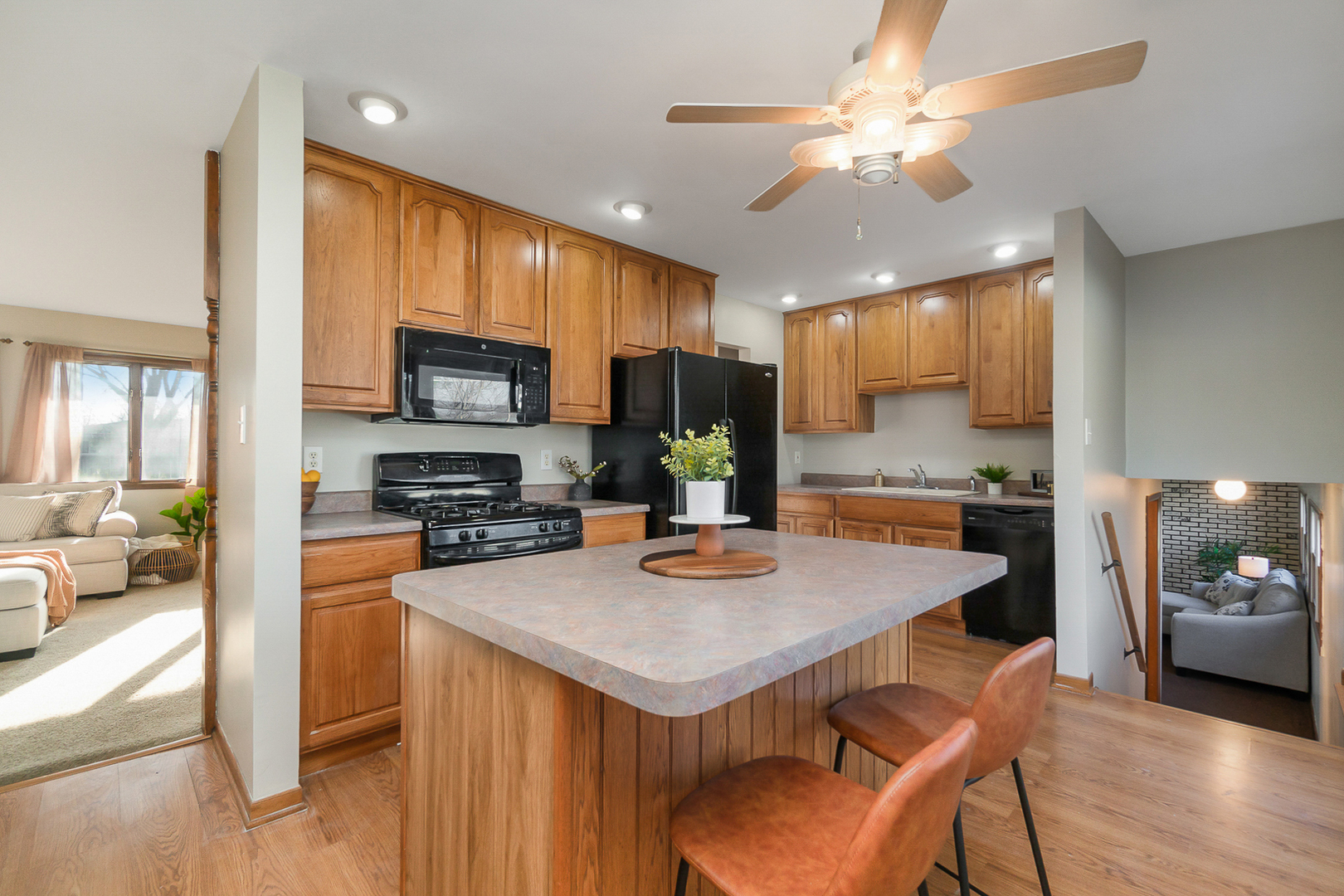 2832 193rd Street Lansing, IL 60438 - Photo 11 of 25 a kitchen with a stove a refrigerator a sink a dining table and chairs