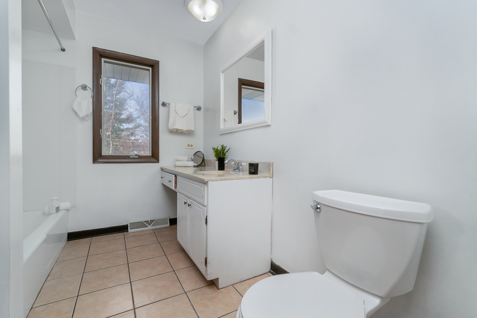 2832 193rd Street Lansing, IL 60438 - Photo 16 of 25 a bathroom with a toilet sink and mirror