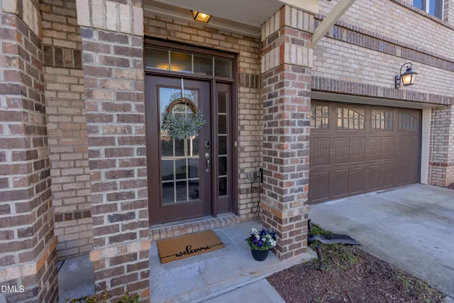 a view of a brick house with potted plants