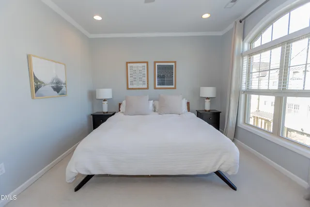 a bedroom with a large bed and a chandelier