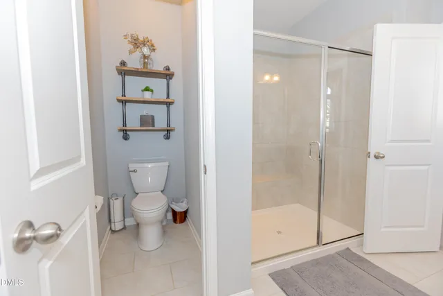 a en suite bathroom with a granite countertop sink and a mirror
