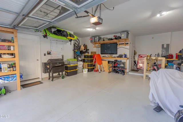 a view of a garage with a lot of stuff and furniture