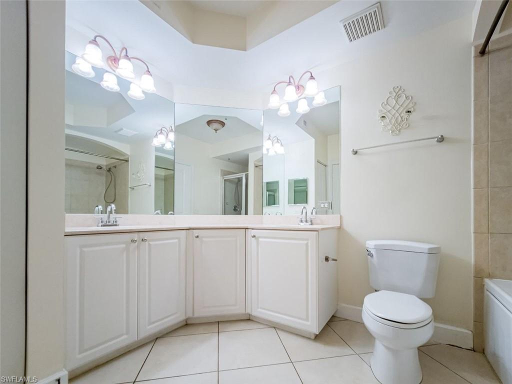 1312 Renaissance Way, Unit 312 Boynton Beach, FL 33426 - Photo 12 of 23 a bathroom with a toilet sink and mirror
