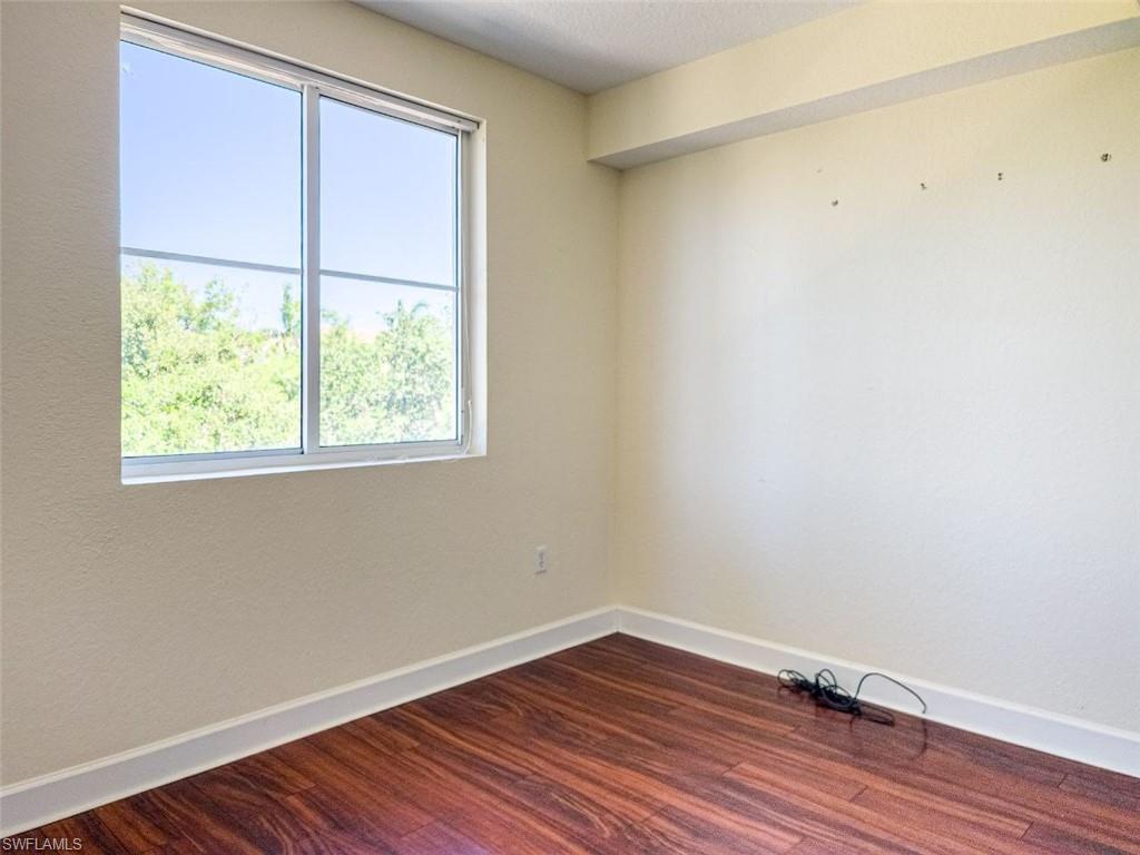 1312 Renaissance Way, Unit 312 Boynton Beach, FL 33426 - Photo 14 of 23 an empty room with wooden floor and windows