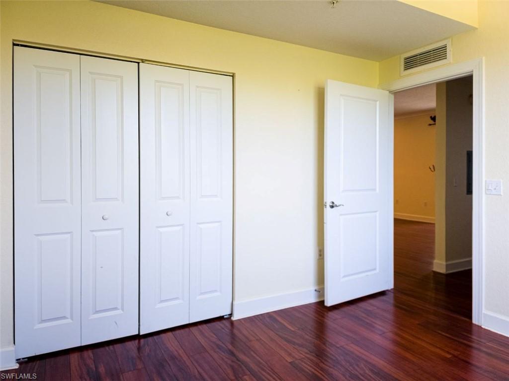 1312 Renaissance Way, Unit 312 Boynton Beach, FL 33426 - Photo 15 of 23 a view of an empty room with closet and wooden floor