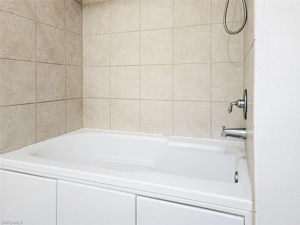1312 Renaissance Way, Unit 312 Boynton Beach, FL 33426 - Photo 17 of 23 a bathroom with a bathtub and shower