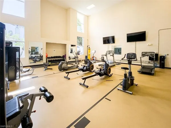 a room with gym equipment and a flat screen tv