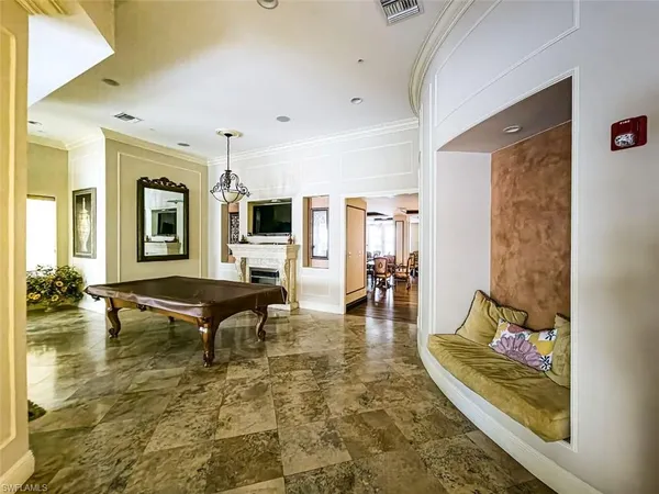 a living room with fireplace furniture and a rug