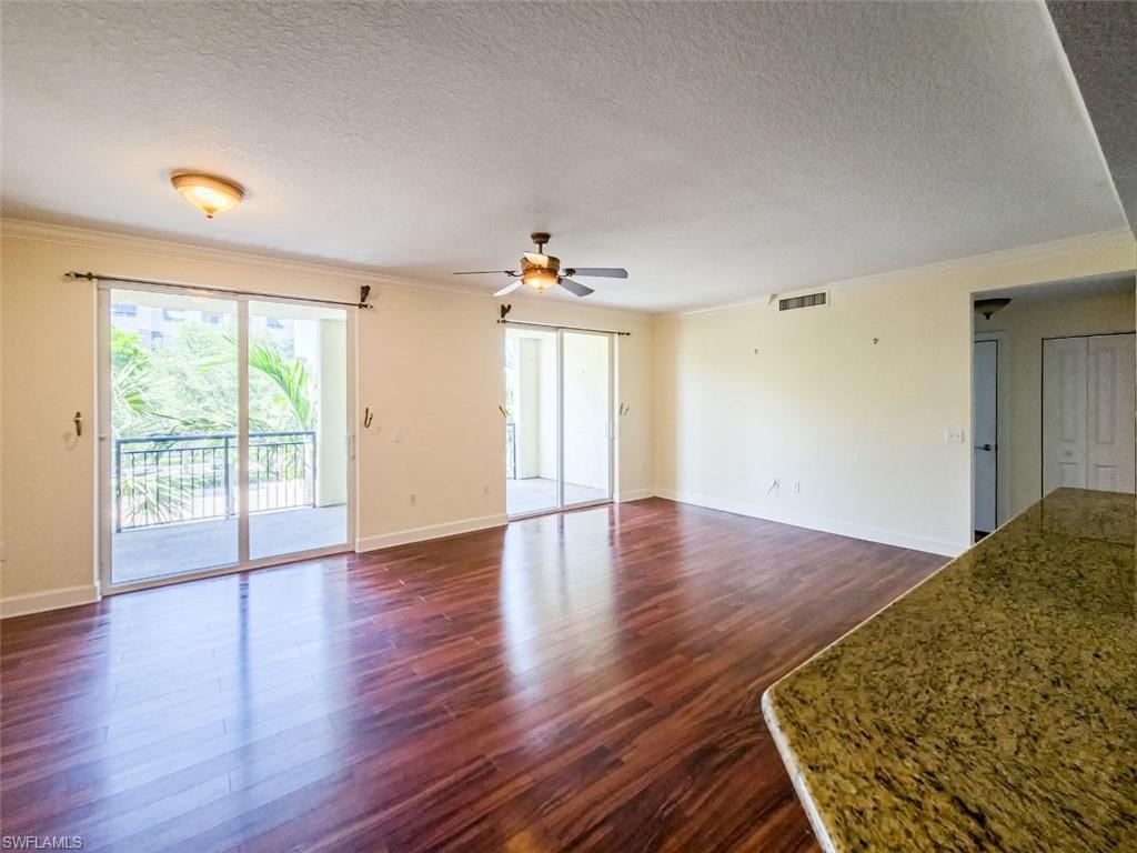1312 Renaissance Way, Unit 312 Boynton Beach, FL 33426 - Photo 6 of 23 an empty room with wooden floor and windows