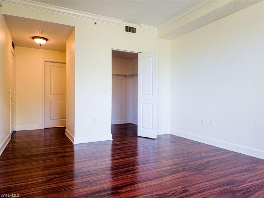 1312 Renaissance Way, Unit 312 Boynton Beach, FL 33426 - Photo 10 of 23 a view of an empty room with wooden floor and a window