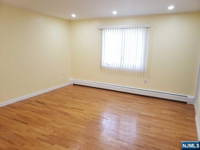 478 Walnut Street Ridgefield, NJ 07657 - Photo 15 of 26 a view of an empty room with wooden floor and a window