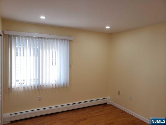 478 Walnut Street Ridgefield, NJ 07657 - Photo 19 of 26 an empty room with wooden floor and windows
