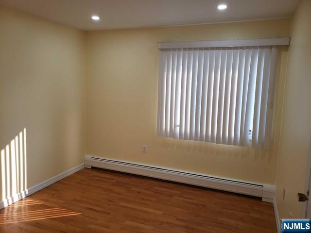 478 Walnut Street Ridgefield, NJ 07657 - Photo 20 of 26 an empty room with wooden floor and windows