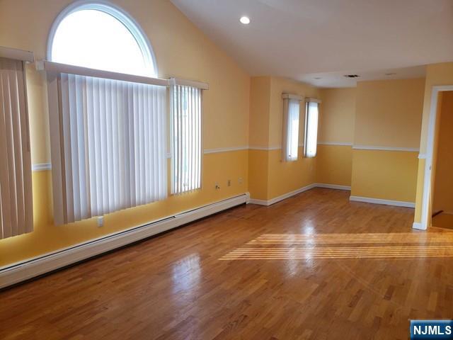 478 Walnut Street Ridgefield, NJ 07657 - Photo 2 of 26 an empty room with wooden floor and windows