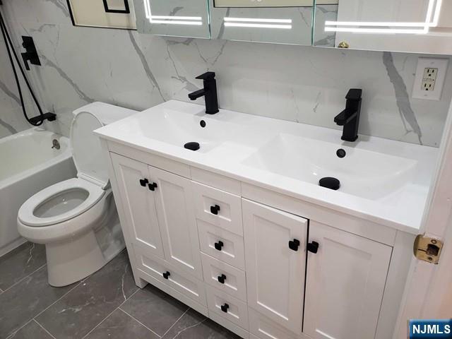 478 Walnut Street Ridgefield, NJ 07657 - Photo 21 of 26 a bathroom with a sink a toilet and a mirror