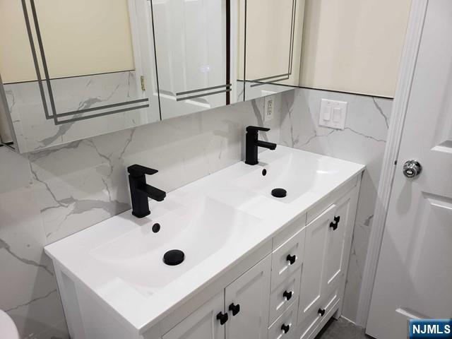 478 Walnut Street Ridgefield, NJ 07657 - Photo 24 of 26 a bathroom with a sink and mirror