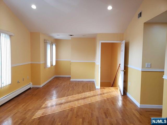 478 Walnut Street Ridgefield, NJ 07657 - Photo 4 of 26 an empty room with wooden floor and windows