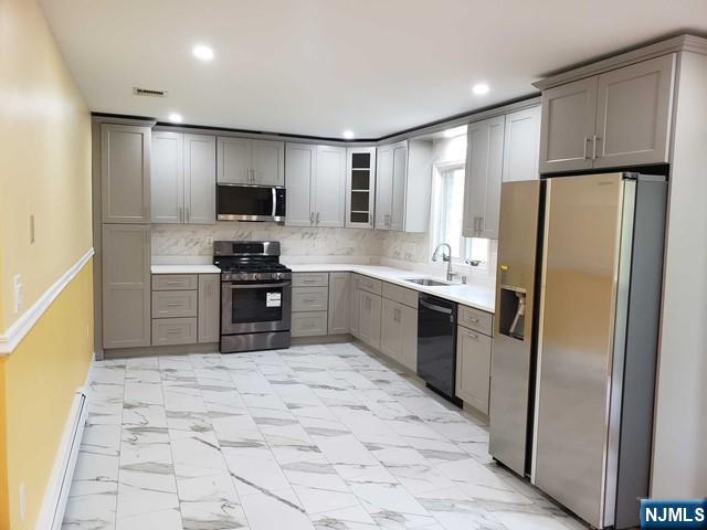 478 Walnut Street Ridgefield, NJ 07657 - Photo 6 of 26 a kitchen with stainless steel appliances granite countertop a refrigerator sink and cabinets