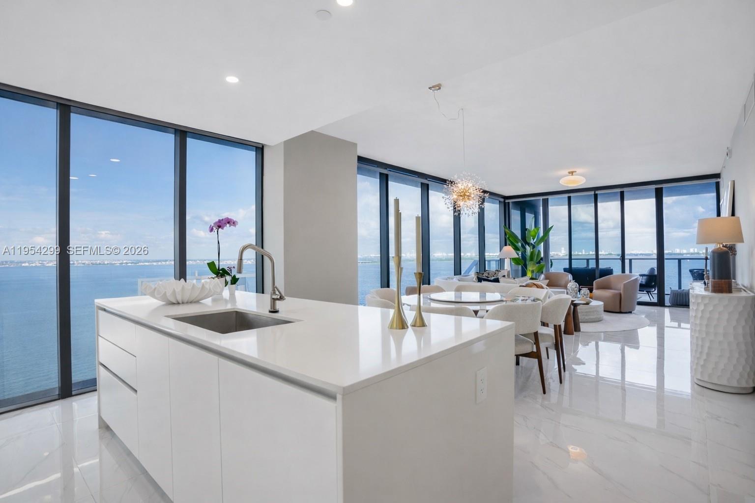 a kitchen with sink refrigerator and large window