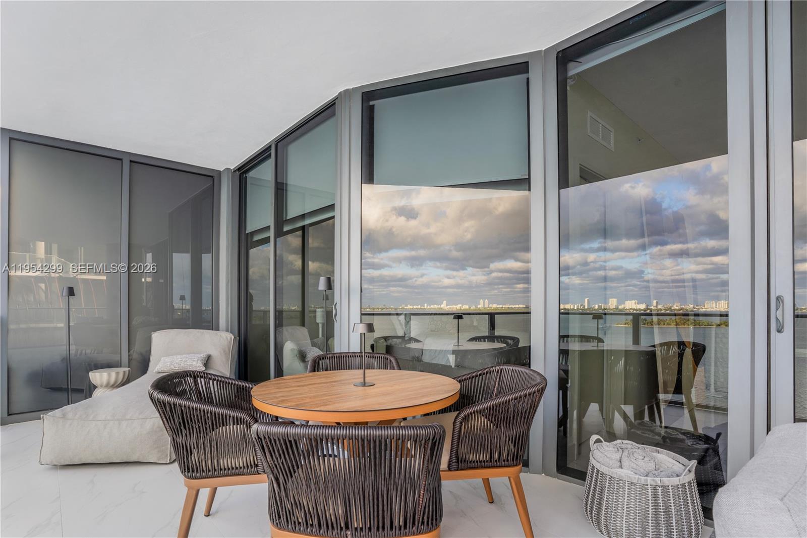 700 Northeast 24th Street, Unit 901 Miami, FL 33137 - Photo 14 of 59 a dining room with furniture a chandelier and glass door