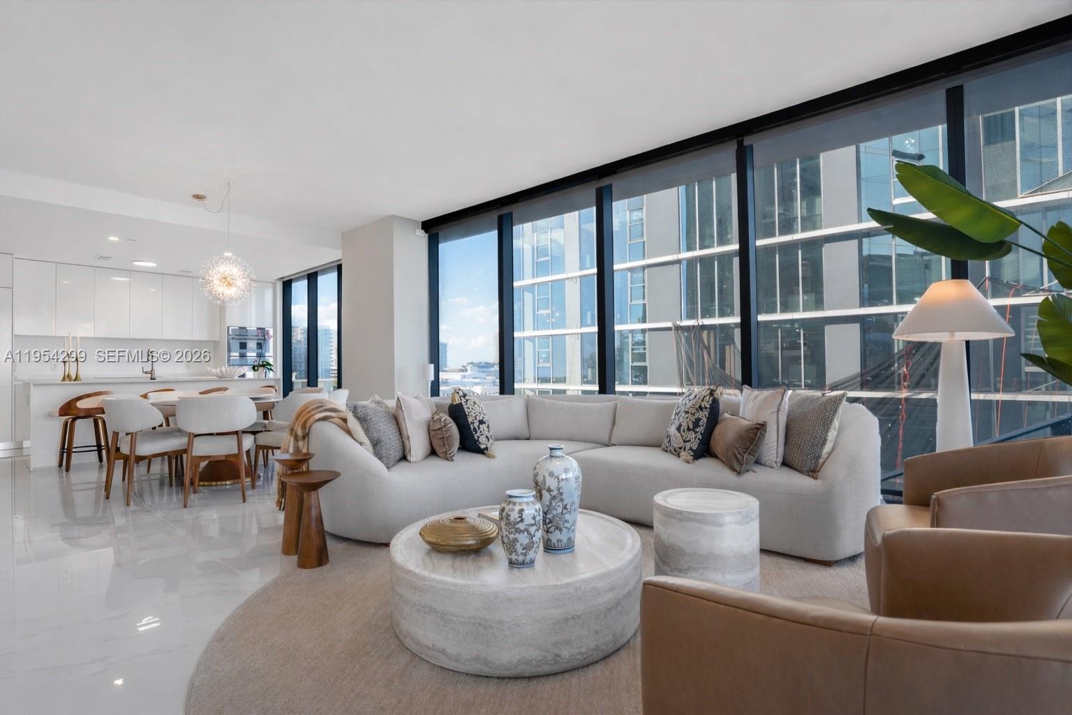 700 Northeast 24th Street, Unit 901 Miami, FL 33137 - Photo 2 of 59 a living room with furniture and a large window