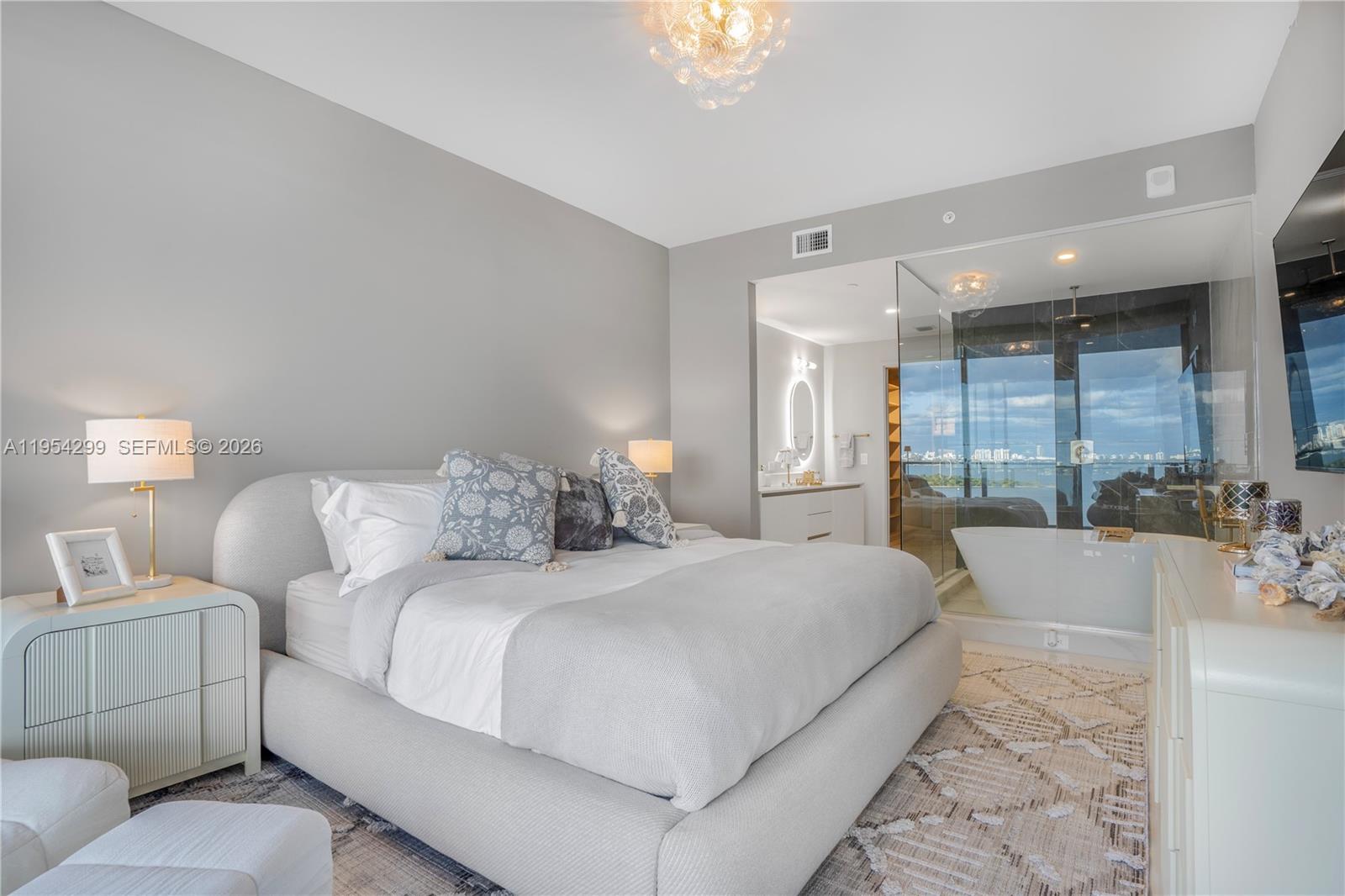 700 Northeast 24th Street, Unit 901 Miami, FL 33137 - Photo 21 of 59 a large bedroom with a large bed and a large window