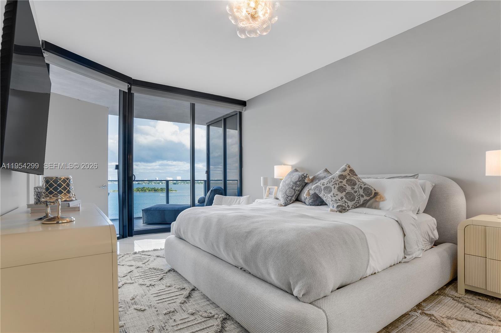 700 Northeast 24th Street, Unit 901 Miami, FL 33137 - Photo 23 of 59 a bedroom with a large bed and a large window