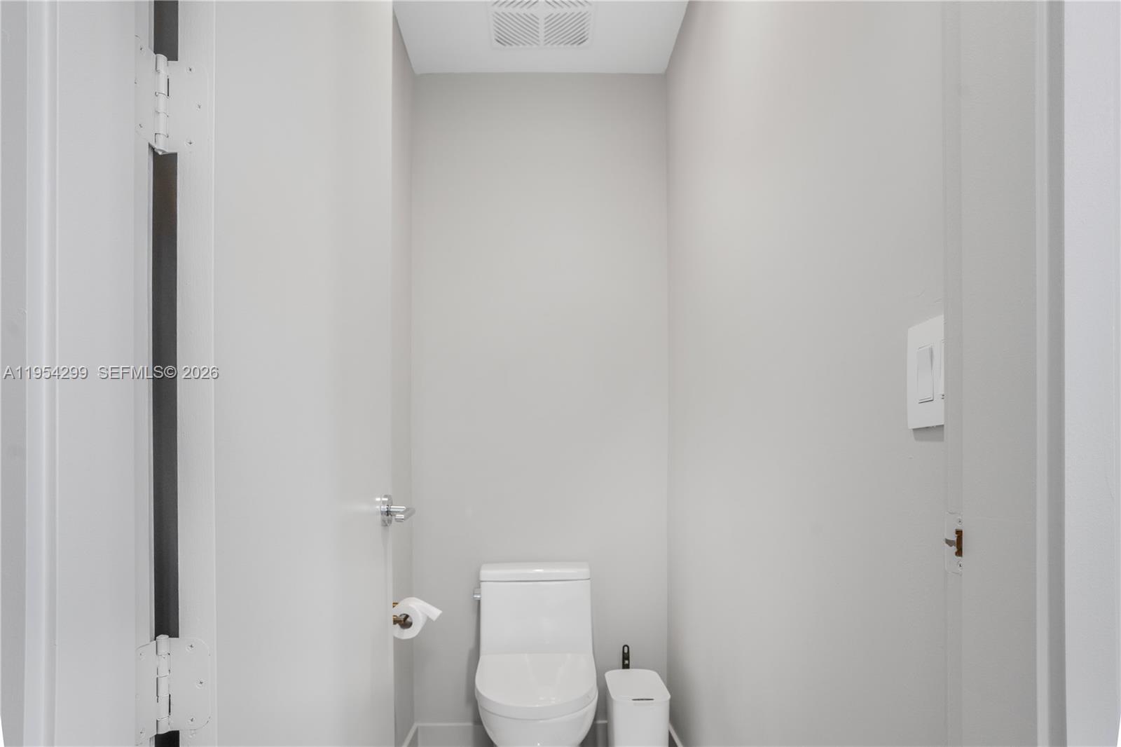 700 Northeast 24th Street, Unit 901 Miami, FL 33137 - Photo 32 of 59 a white toilet sitting next to a white wall
