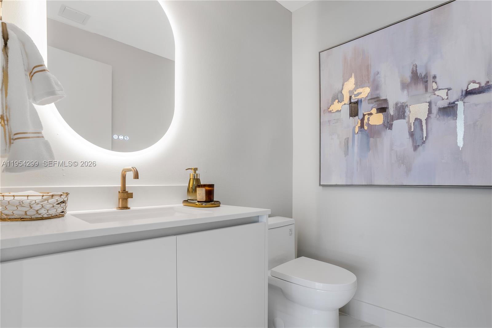 700 Northeast 24th Street, Unit 901 Miami, FL 33137 - Photo 40 of 59 a bathroom with a toilet sink and mirror