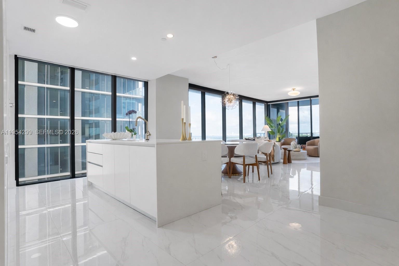700 Northeast 24th Street, Unit 901 Miami, FL 33137 - Photo 4 of 59 a living room with furniture and a large window