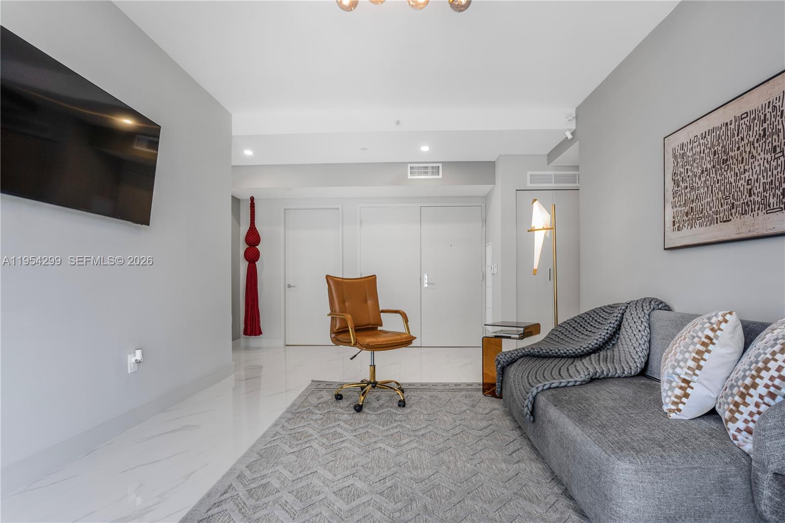 700 Northeast 24th Street, Unit 901 Miami, FL 33137 - Photo 41 of 59 a living room with furniture and a flat screen tv