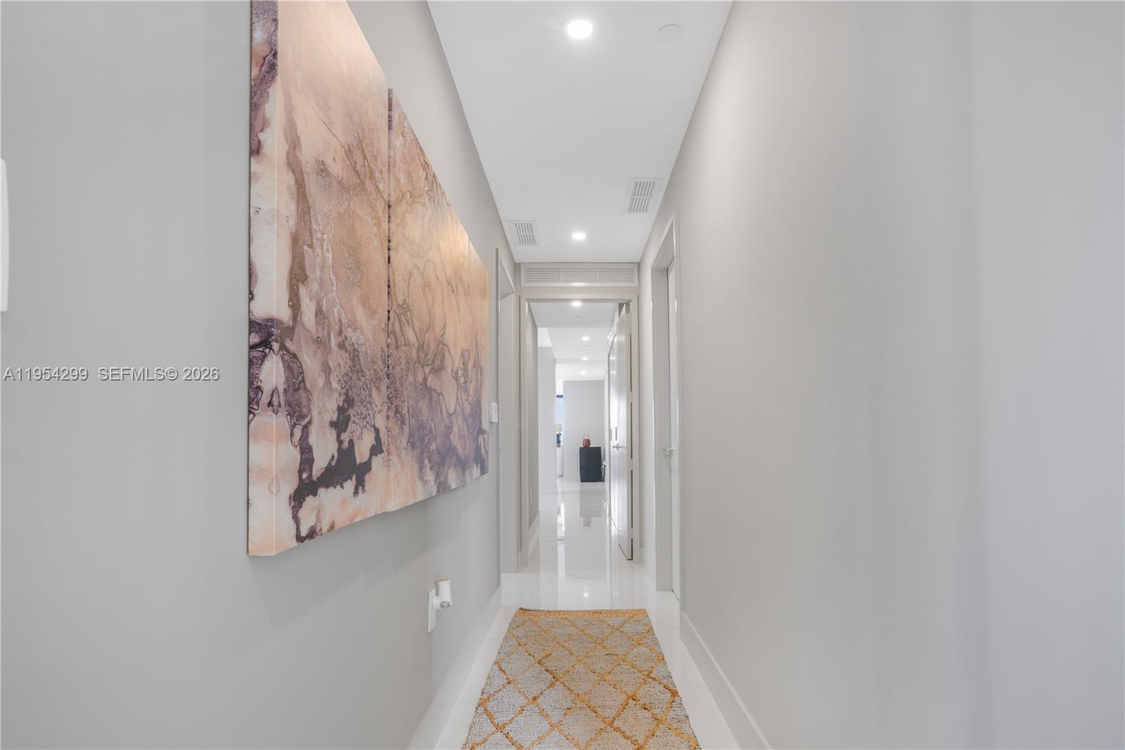 700 Northeast 24th Street, Unit 901 Miami, FL 33137 - Photo 43 of 59 a view of a hallway with wooden floor and a bathroom