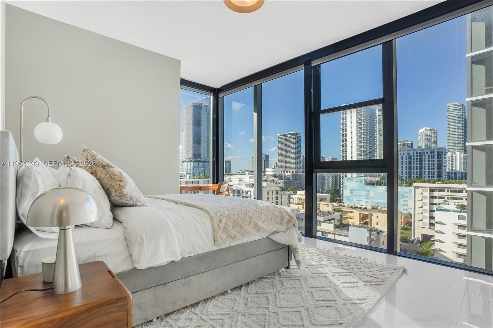 700 Northeast 24th Street, Unit 901 Miami, FL 33137 - Photo 48 of 59 a spacious bedroom with a bed and window