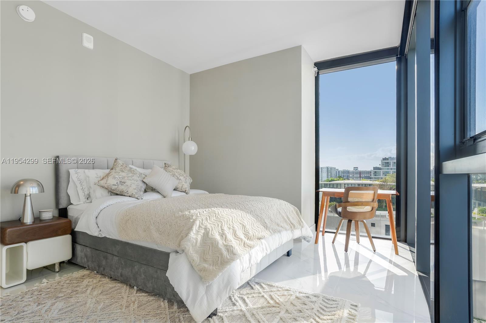 700 Northeast 24th Street, Unit 901 Miami, FL 33137 - Photo 49 of 59 a bedroom with a bed and a view of living room