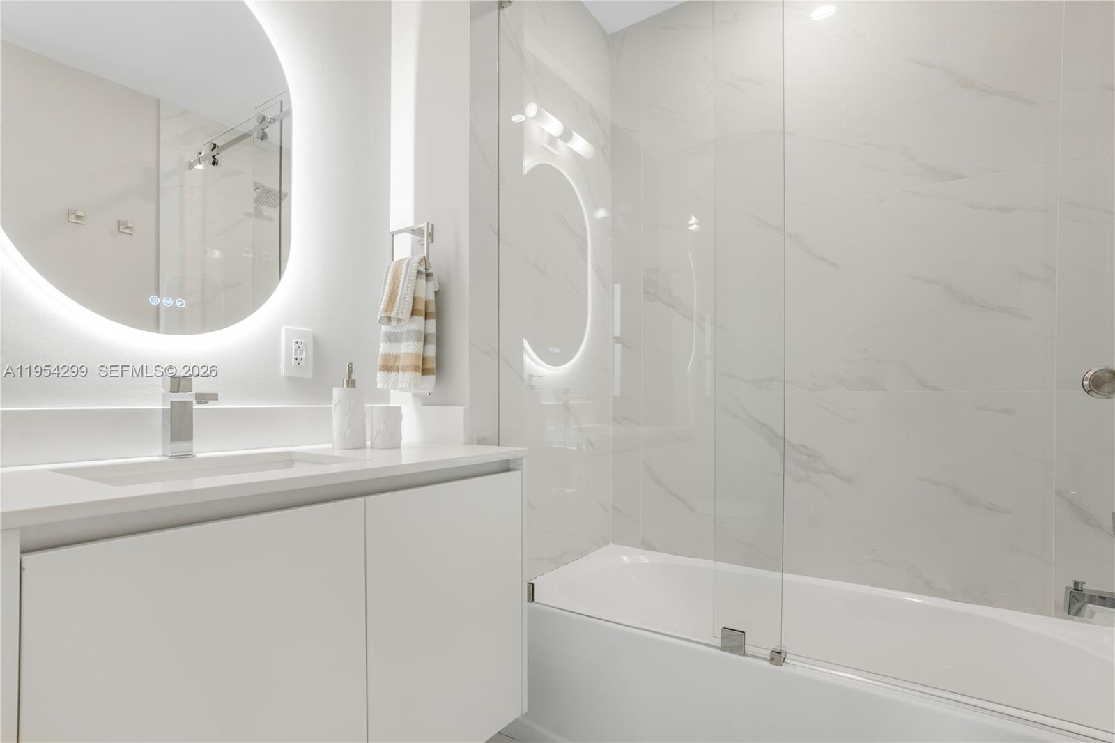 700 Northeast 24th Street, Unit 901 Miami, FL 33137 - Photo 58 of 59 a bathroom with a sink a toilet and a mirror