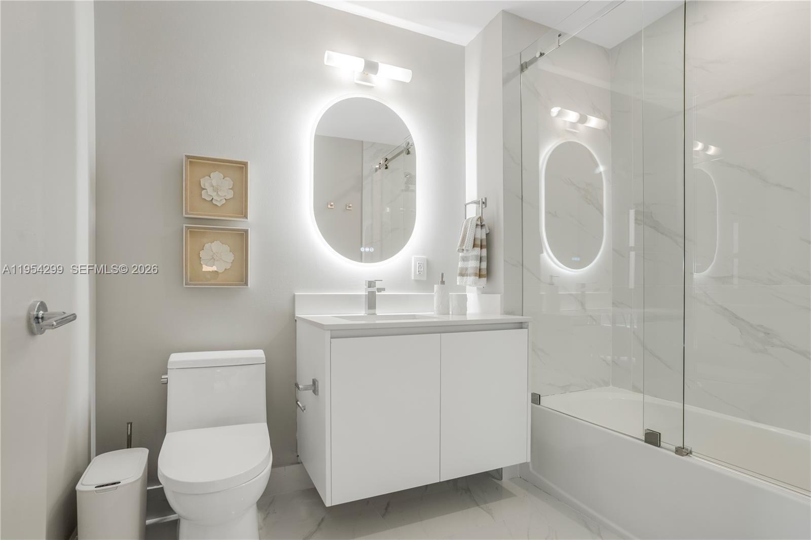 700 Northeast 24th Street, Unit 901 Miami, FL 33137 - Photo 59 of 59 a bathroom with a toilet sink and bathtub