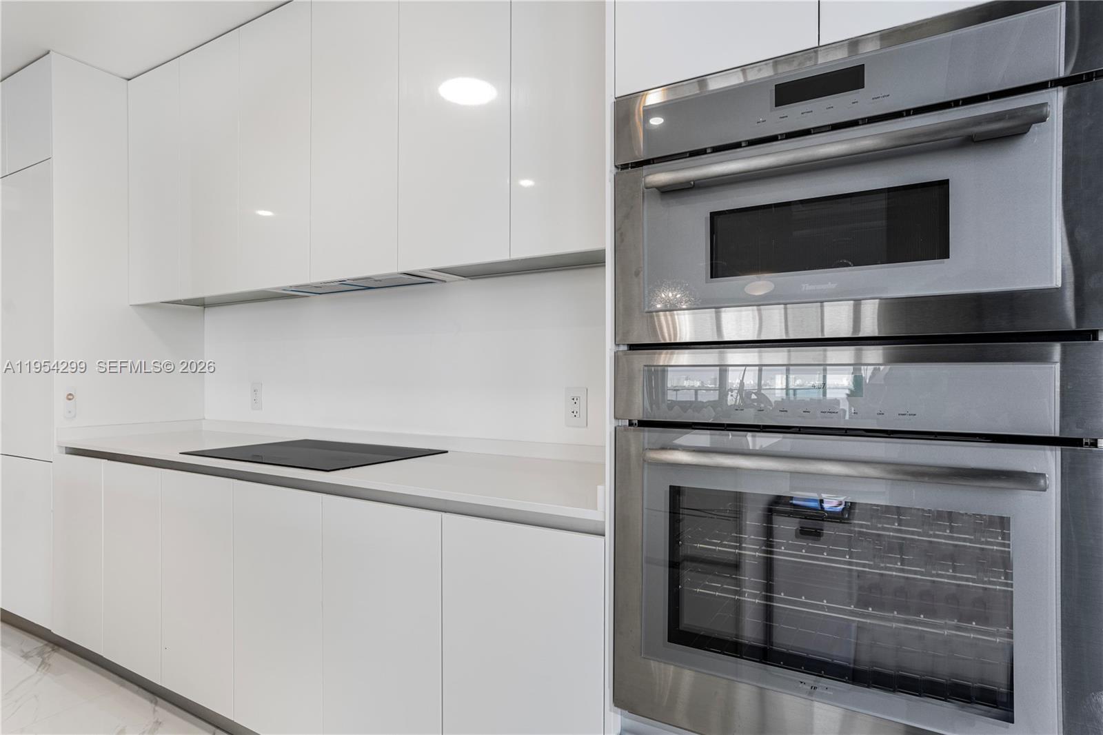 700 Northeast 24th Street, Unit 901 Miami, FL 33137 - Photo 7 of 59 a stove top oven sitting inside of a kitchen