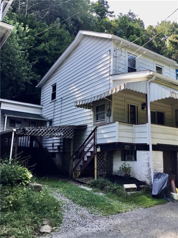724 7th Avenue Ford City, PA 16226 - Photo 1 of 25 a front view of a house with a garden