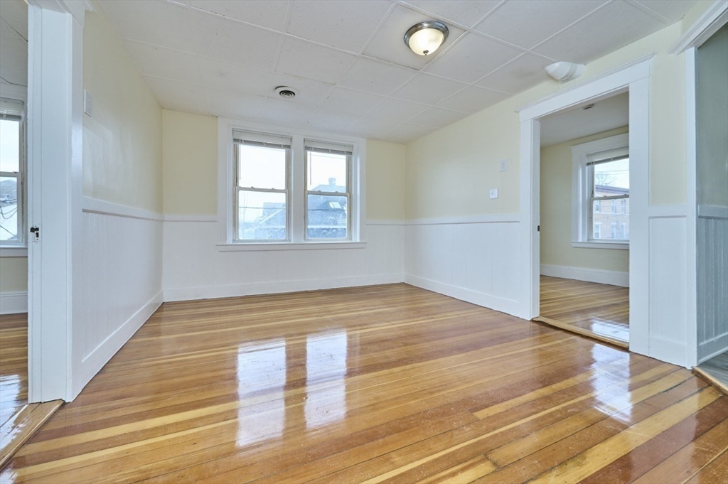 44 Park Street, Unit 3 Salem, MA 01970 - Photo 9 of 15 a view of empty room with wooden floor and fan