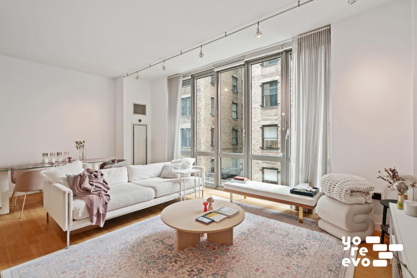 4 West 21st Street, Unit 7A Manhattan, NY 10010 - Photo 2 of 9 a living room with furniture and a large window