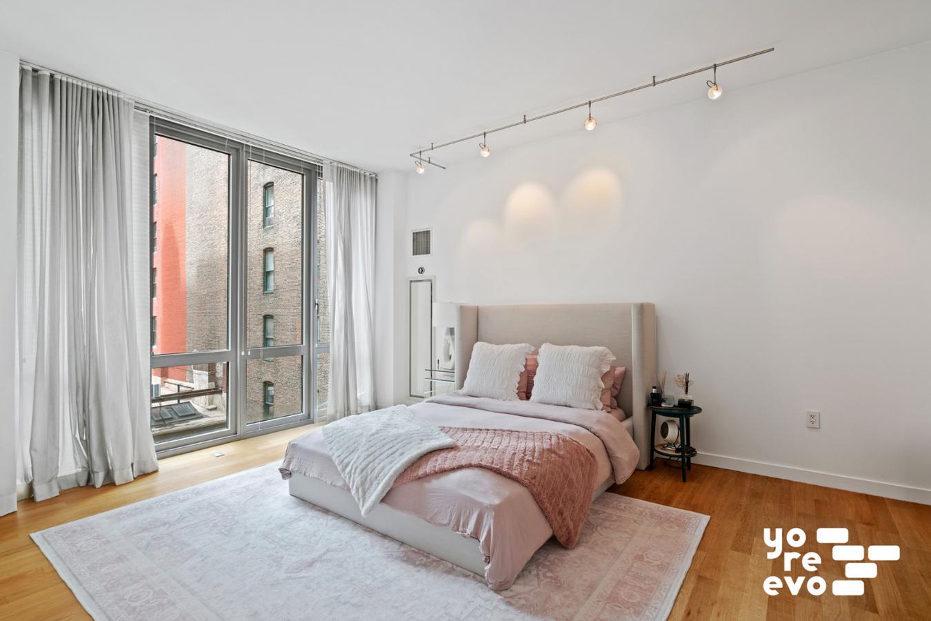 4 West 21st Street, Unit 7A Manhattan, NY 10010 - Photo 4 of 9 a bedroom with a bed and a night stand