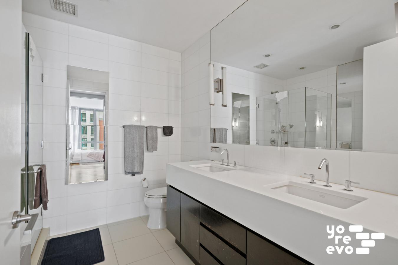 4 West 21st Street, Unit 7A Manhattan, NY 10010 - Photo 6 of 9 a bathroom with a double vanity sink mirror and toilet