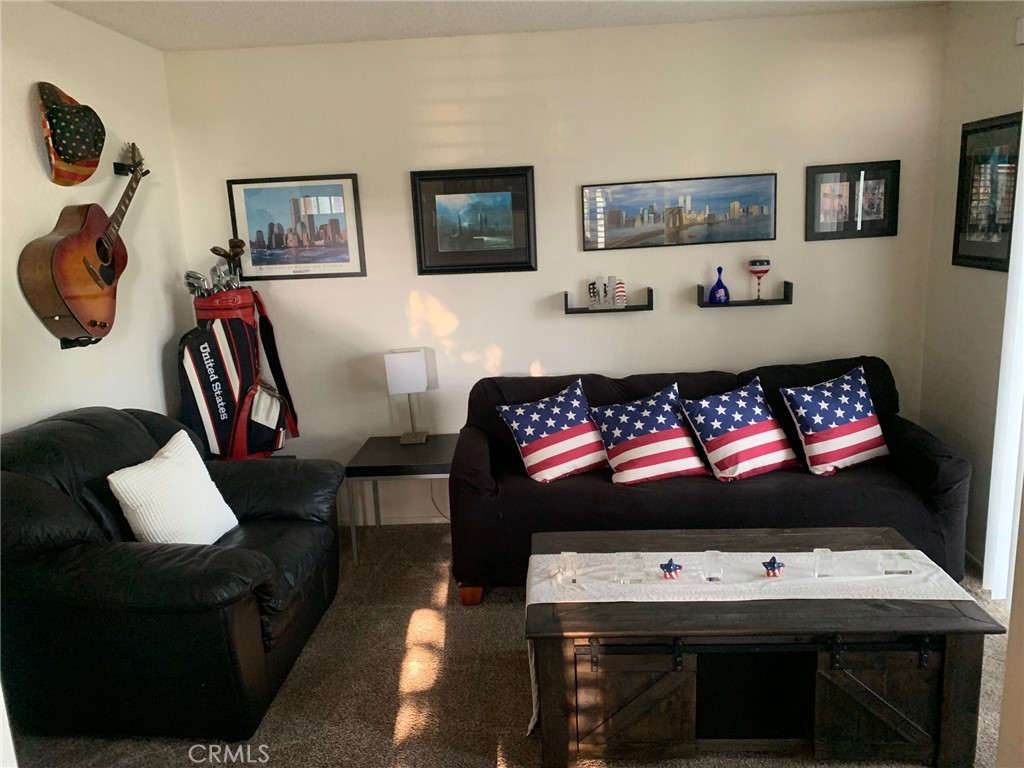 15 Elmbrook, Unit 52 Aliso Viejo, CA 92656 - Photo 3 of 10 a living room with furniture and a flat screen tv